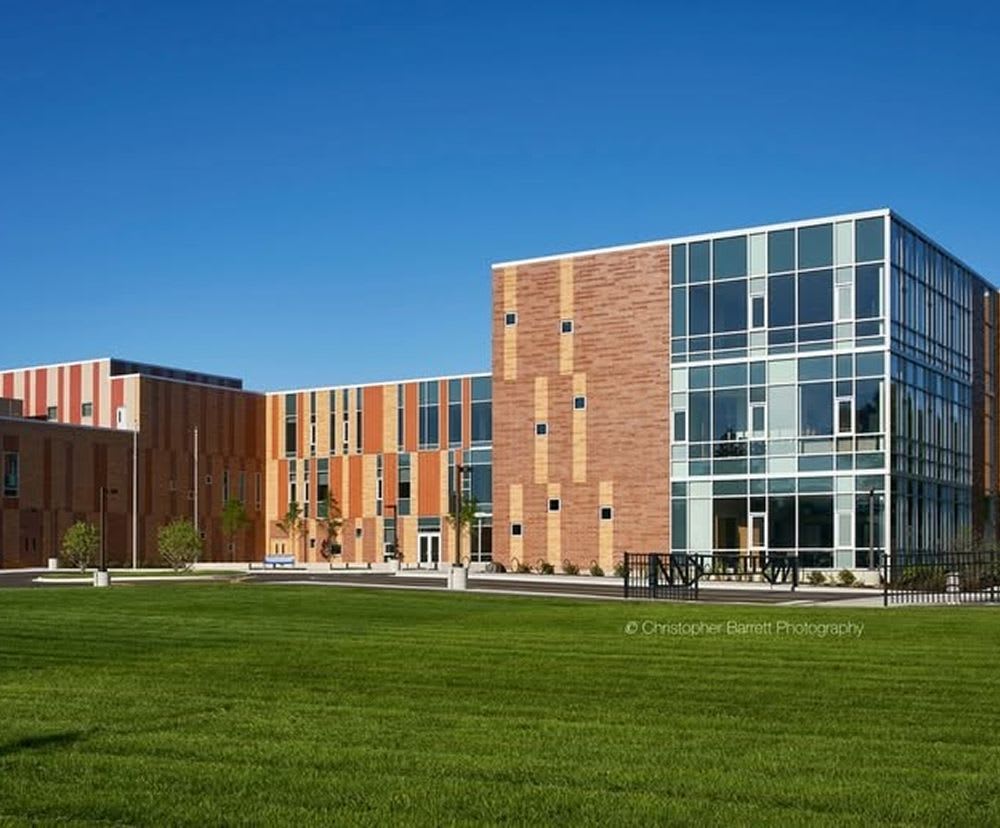 The exterior of East Prairie School surrounded by a large grass field.