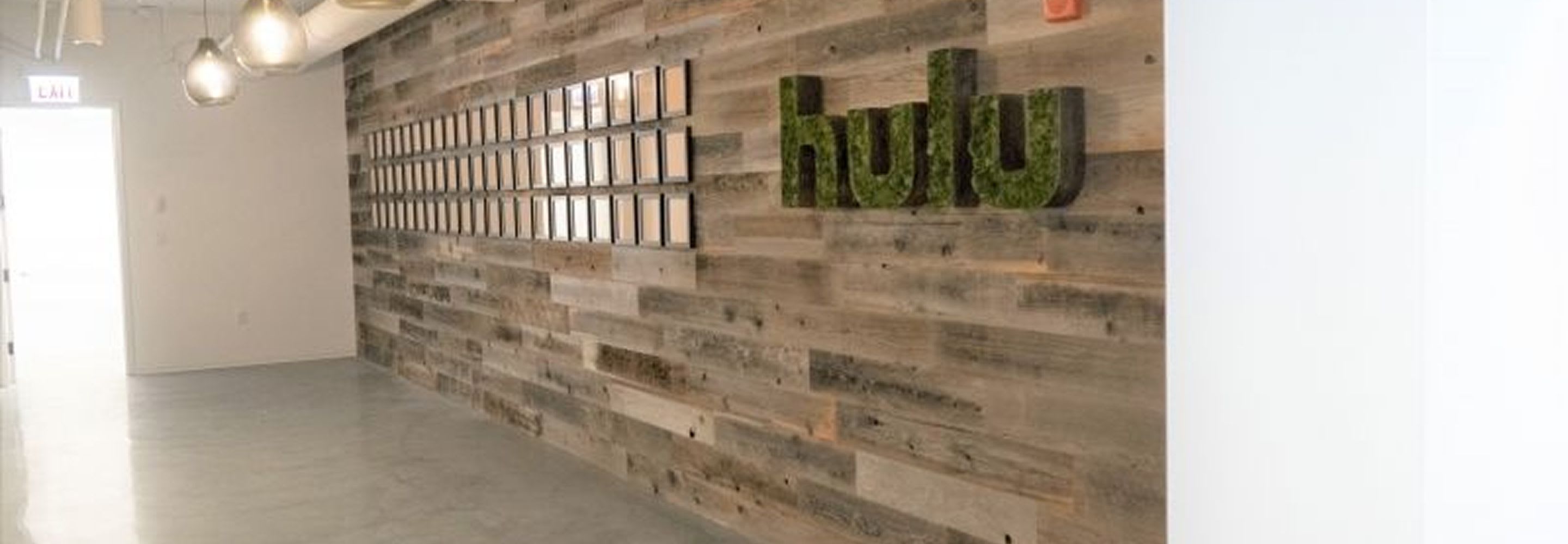 Outside hallway with pendant light fixtures and the words "Hulu" on the wall.