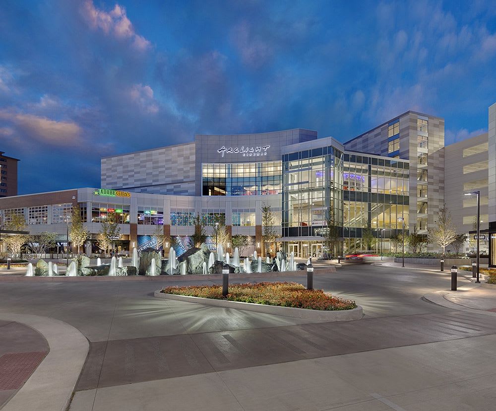 The outside of New City, illuminated by store and pole lights later during the day.