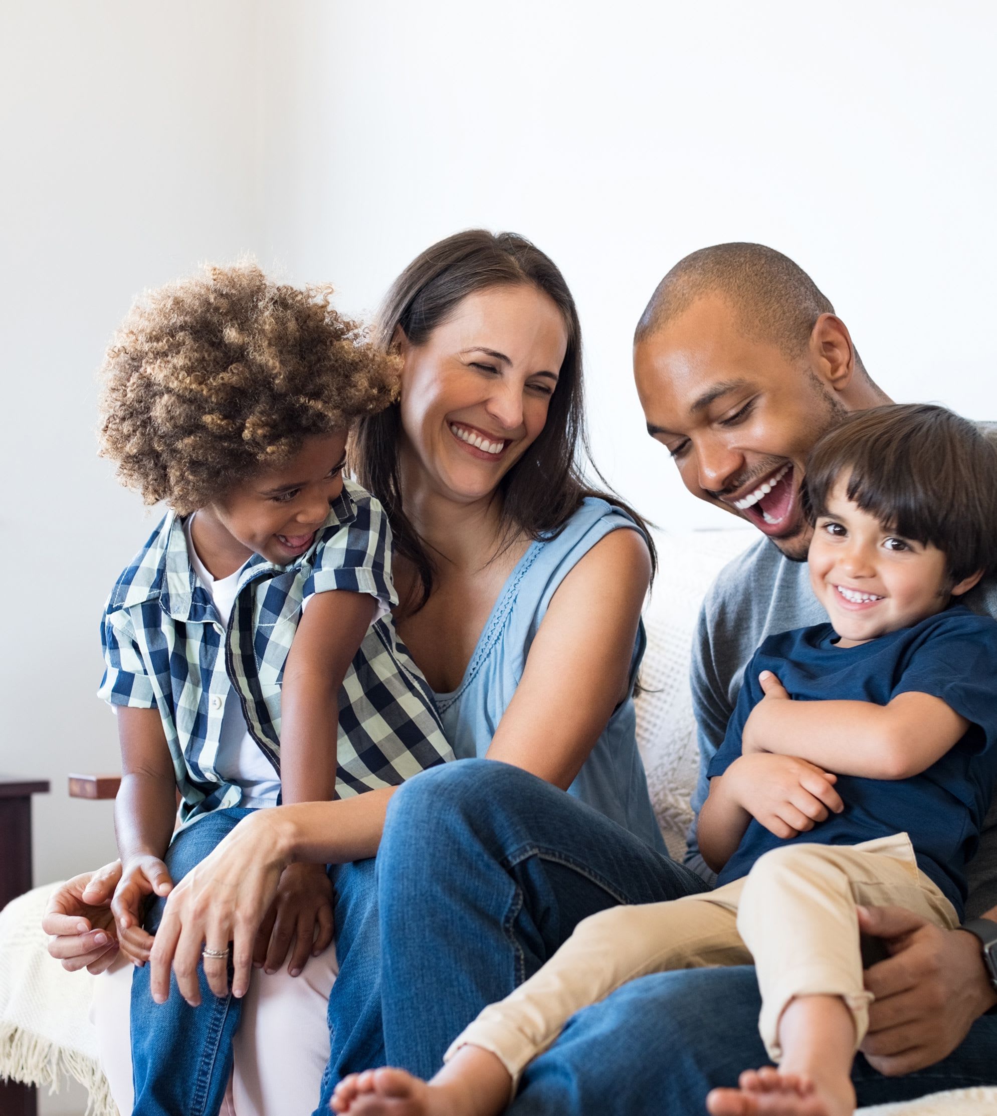mom and dad sit with their two sons