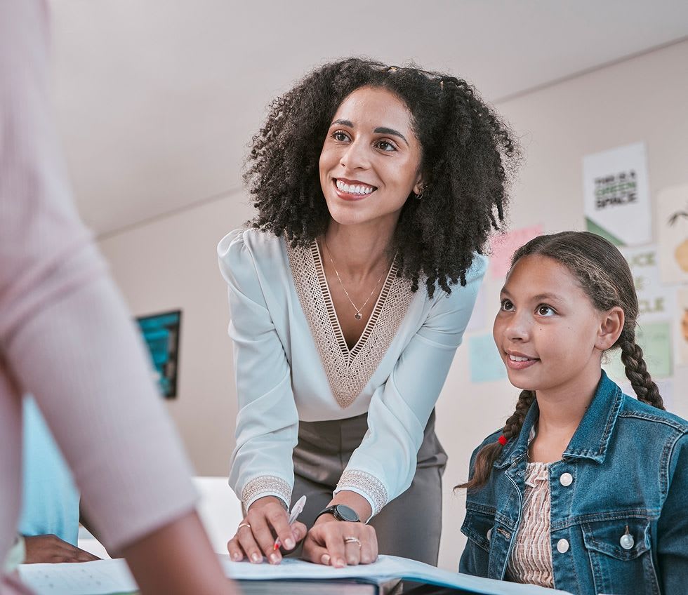 parent and teacher helping student with schoolwork
