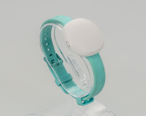 White sensor pod with a teal rubber strap to track fertility on display.