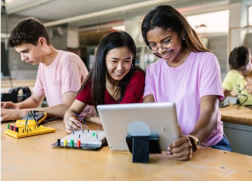 girls in a STEM enrichment program work on robotics project