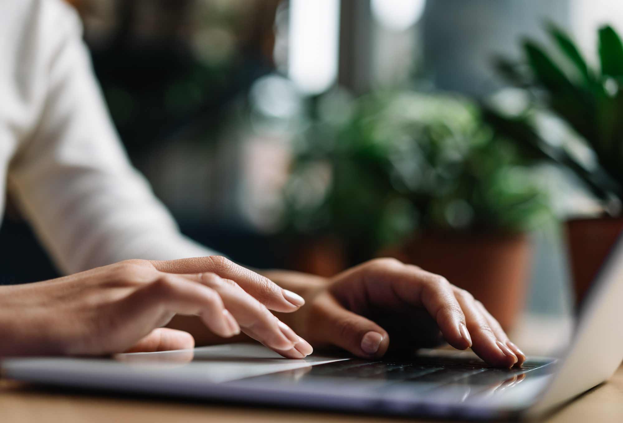 Hands typing on computer