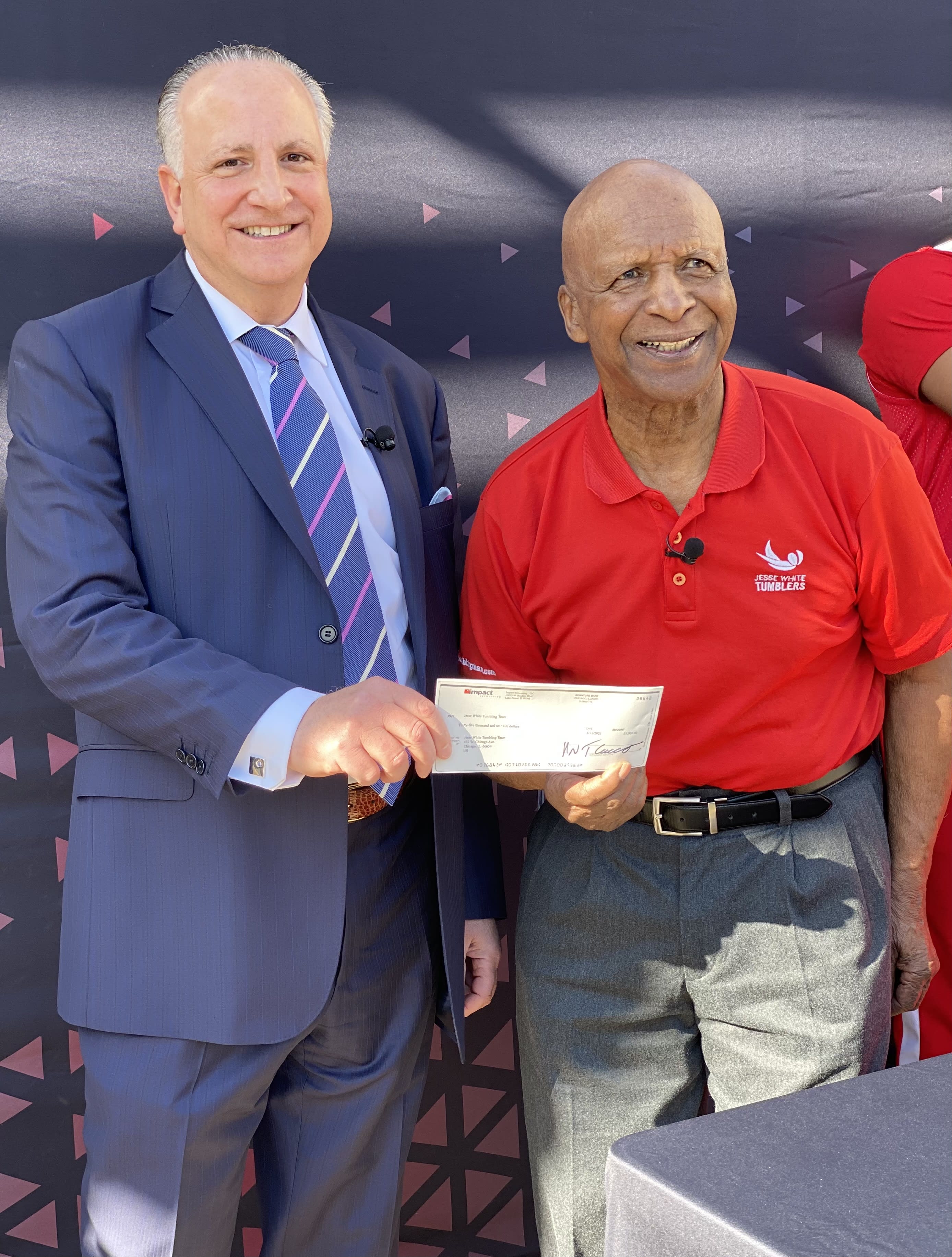 Impact CEO Frank Cucco Presents Illinois Secretary of State Jesse White with donation check