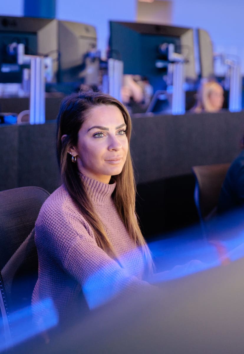 woman working at desk in high tech office with blue lights
