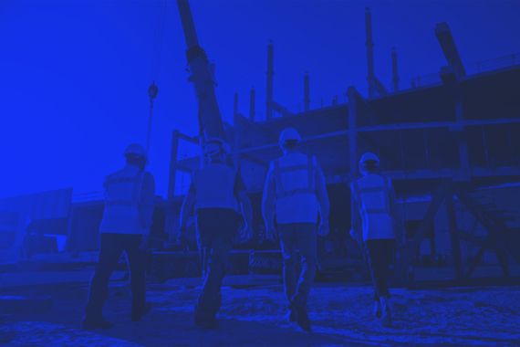 Blue-toned photo of construction workers on site | Cybersecurity Services