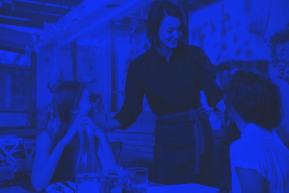 Blue-toned photo of a waitress serving guests | DOT Cybersecurity Services