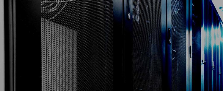 Server racks lined up with blue haze and light reflecting off them