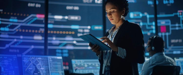 Woman holding a tablet in security operations center