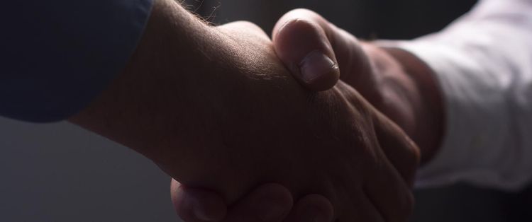 Close-up of two people shaking hands | What Does a Managed Service Relationship Look Like?