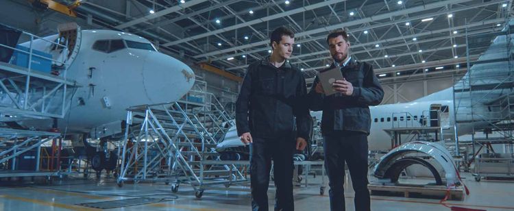 Two aerospace engineers looking at data | A Rundown of CMMC Aerospace Industry Regulations