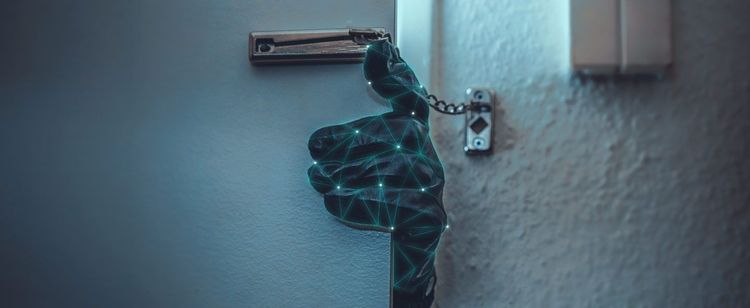 A suspicious glove covered in green techy lines is pushing open a door. | Notable Recent Data Breaches in 2022 | DOT Security