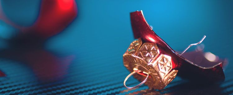 A broken Christmas ornament appears over a blue background. | Top 6 Holiday Scams | DOT Security
