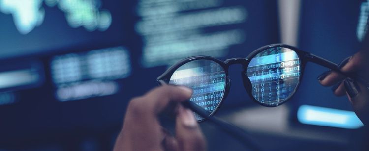 glasses being held up to a screen | cybersecurity news, trends, and tips for december 2022