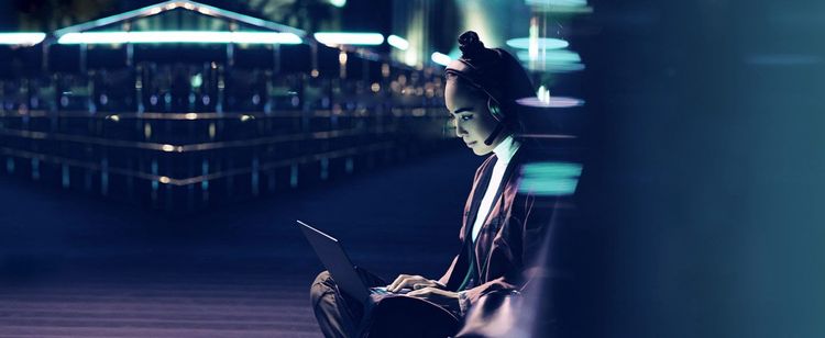 A woman working in tech types on her laptop. | Cybersecurity News Update: January 2023 | DOT Security