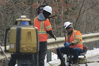 Two URETEK technicians in safety gear and winter clothing