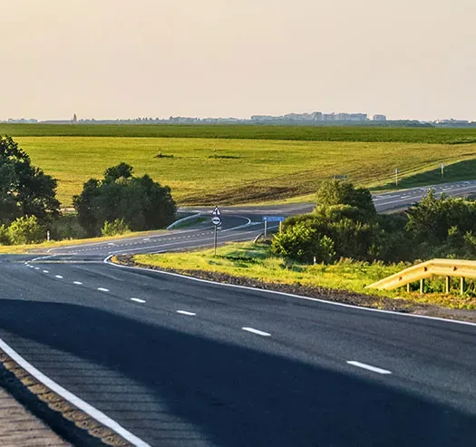 Roadway with grassy field