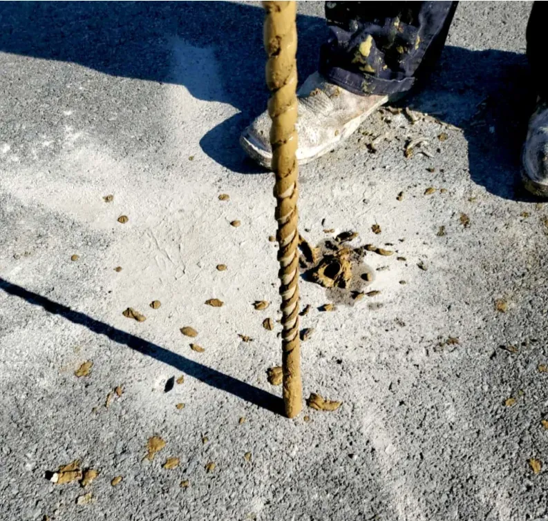 Close up of drill in hole in pavement