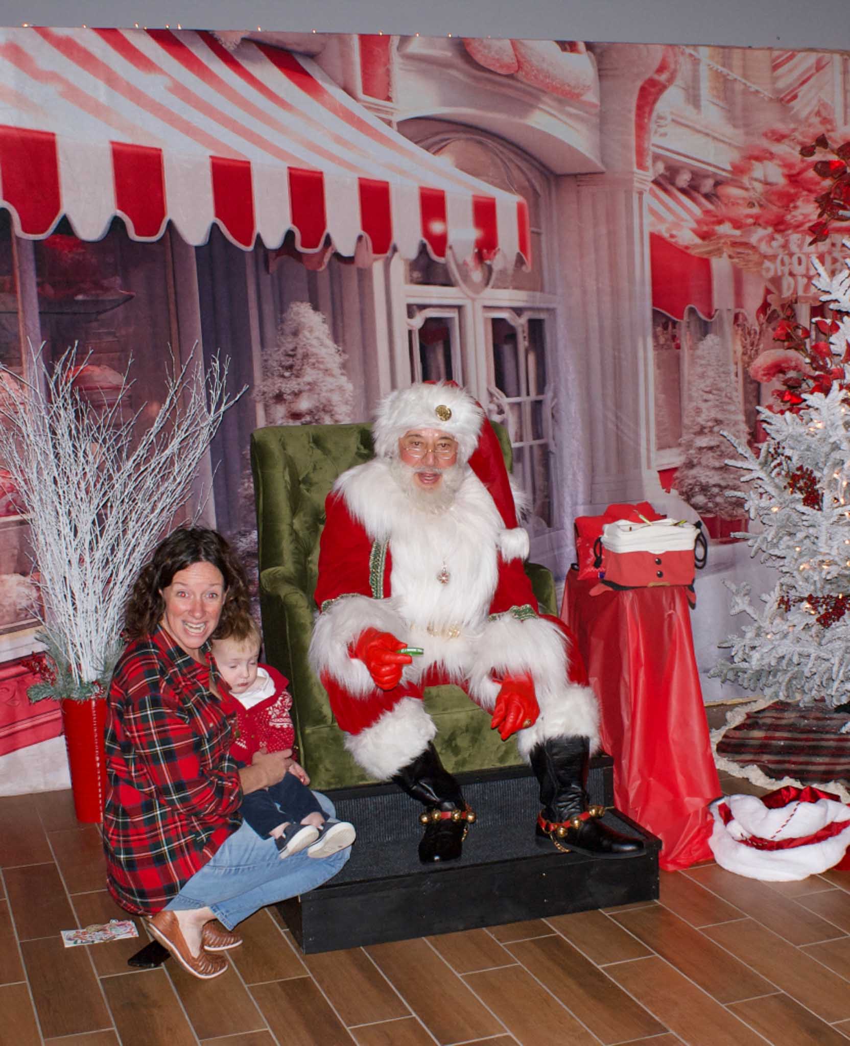 A mother and small toddler meet Santa at Geneva National Community's holiday event