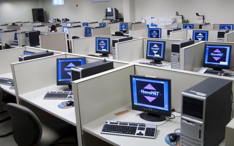 Four rows of computers and cubicles displaying an image and the words "NovaNet".