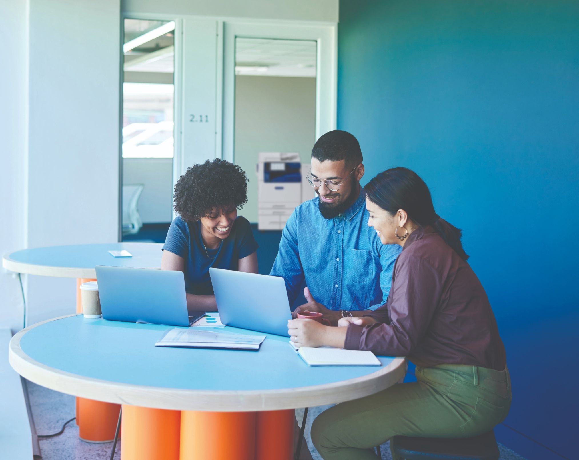 A group of people sitting in an office holding a meeting