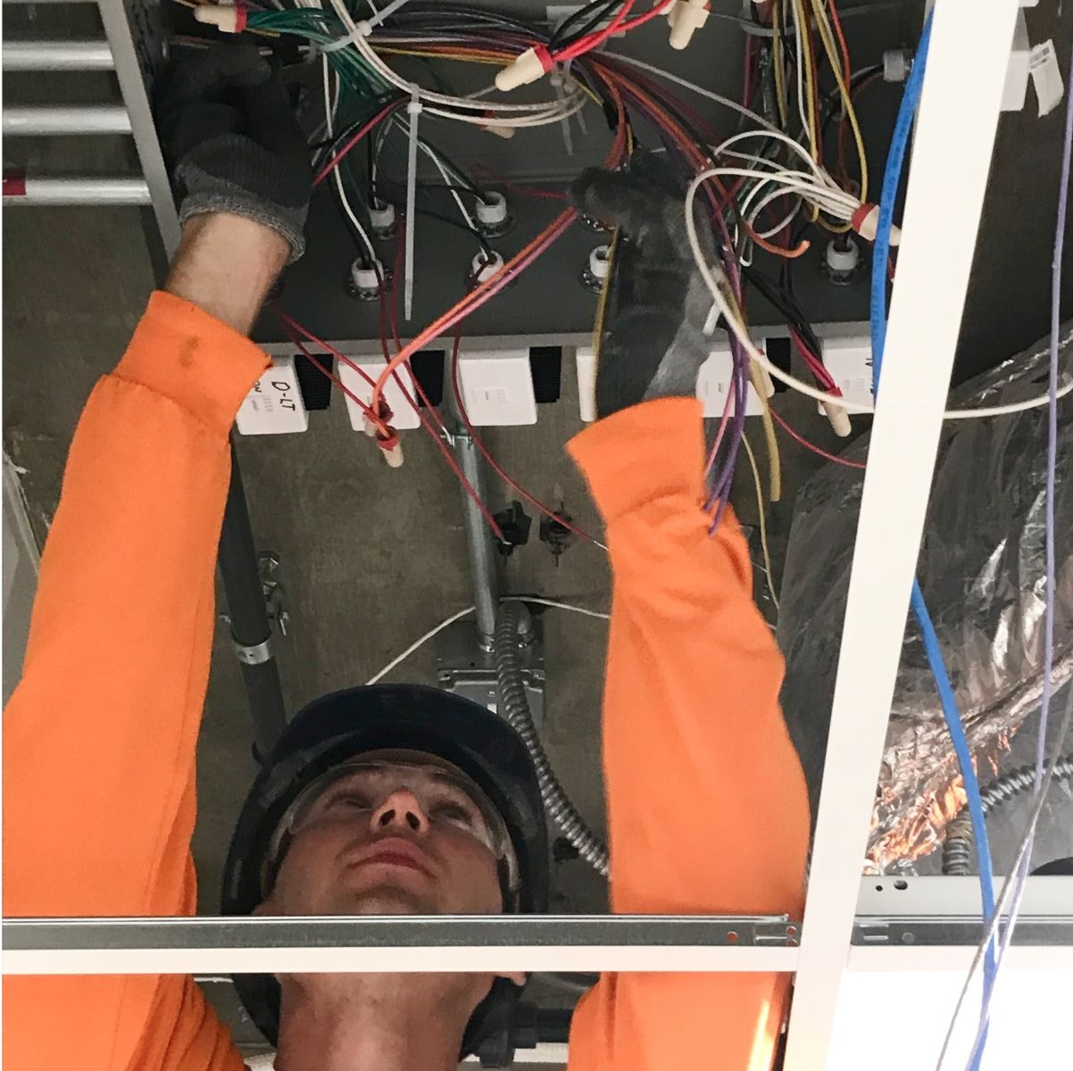 Electrical Construction Engineer connecting wires on a project site.
