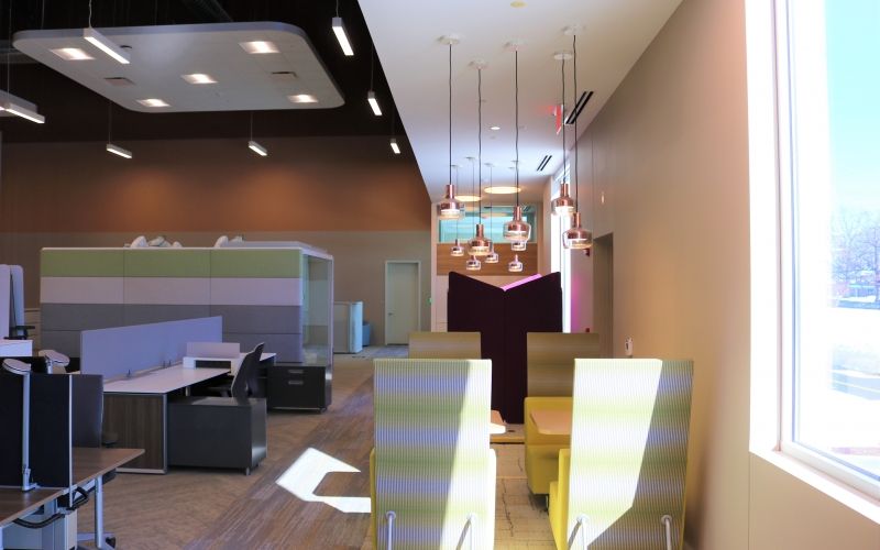 Office working space for Forward Space with a couple chairs, tables and lighting.