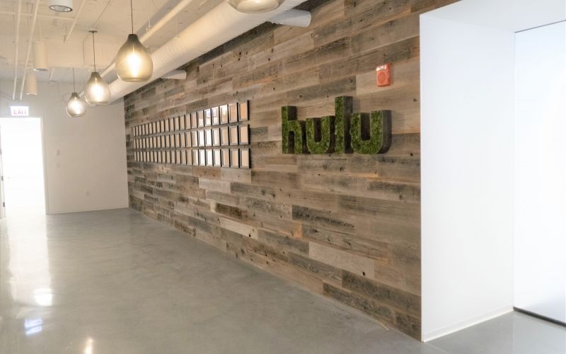 Outside hallway with pendant light fixtures and the words "Hulu" on the wall.