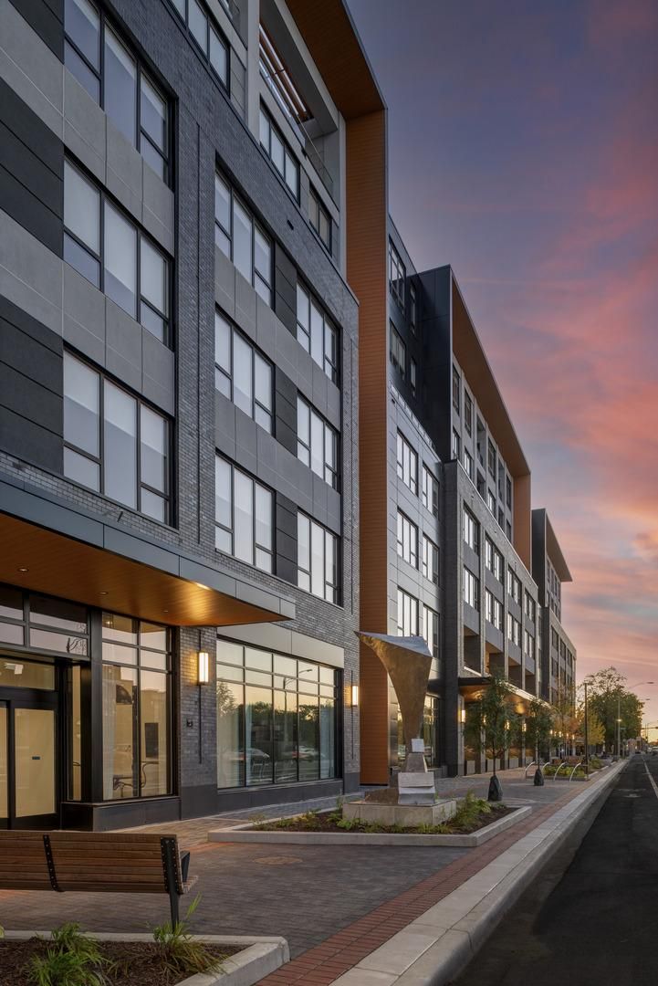 A view of the external facade of American House Oak Park Senior Living during sunset.