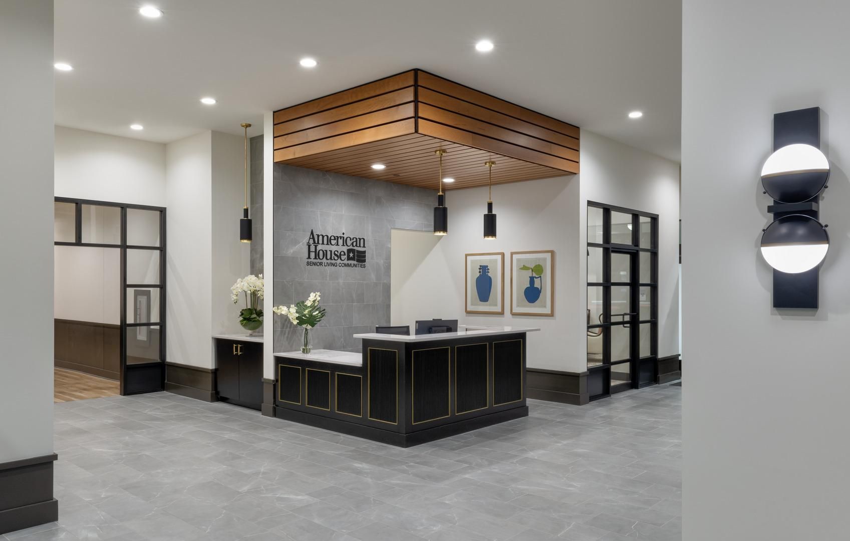 The lobby welcome desk at American House Oak Park Senior Living with bright lighting.