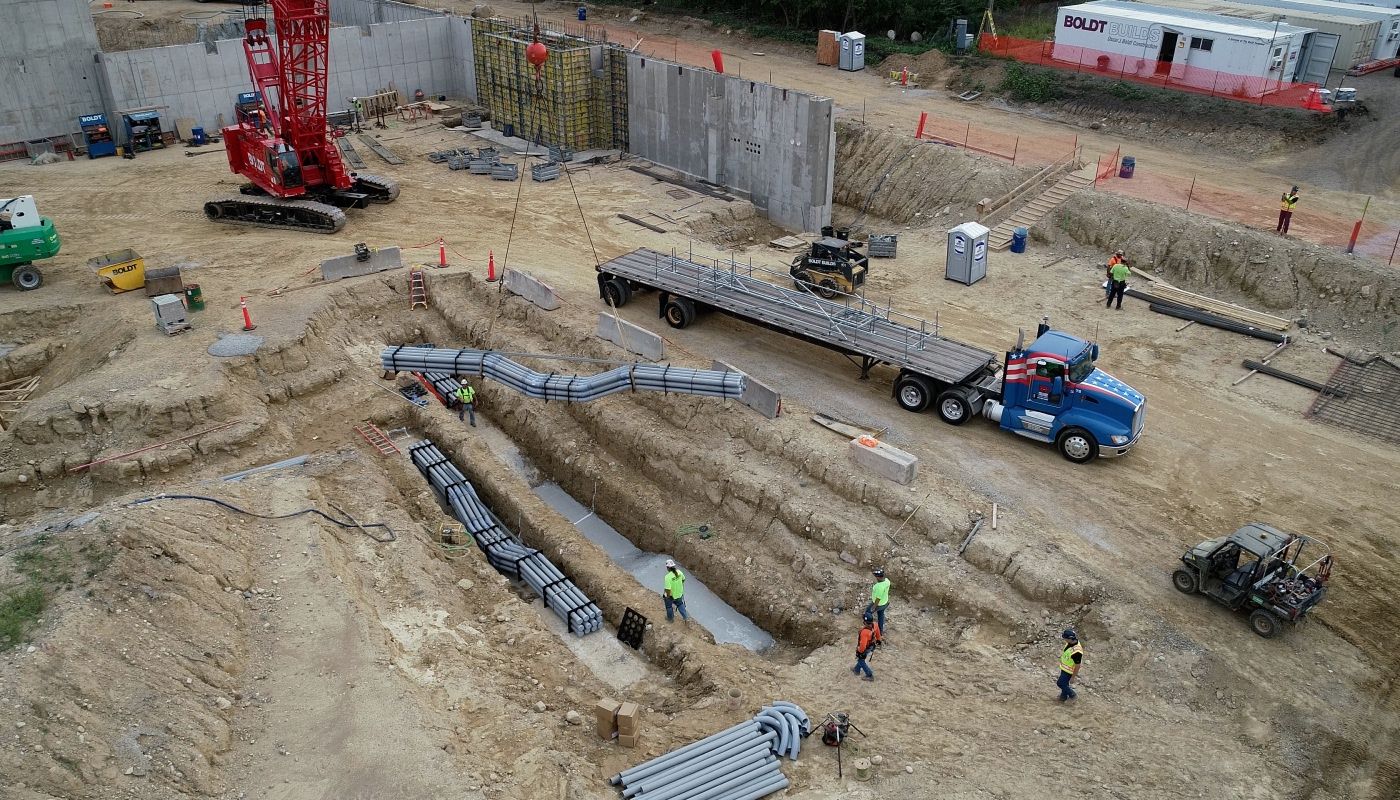 Electrical Construction site placing prefabricated duct banks underground