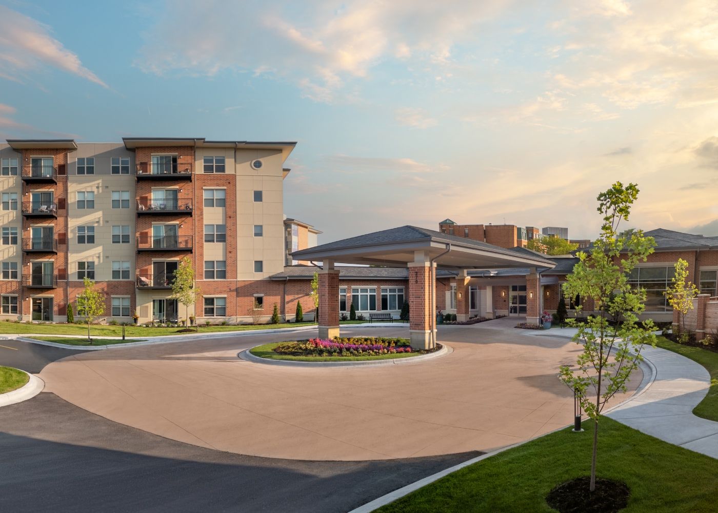 Oak Trace entrance during sunset with outdoor lights shining.