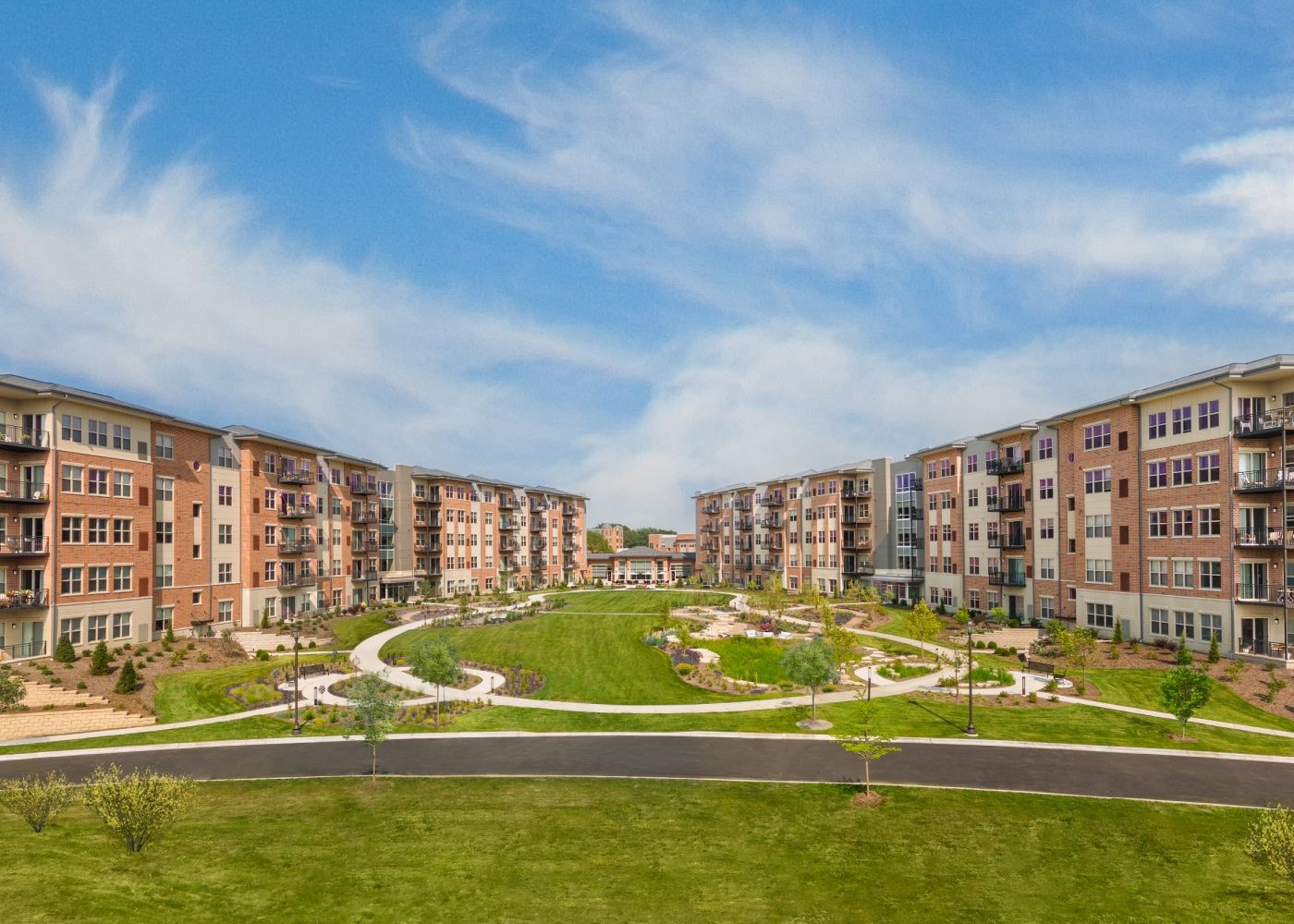 Exterior view of the large property alongside green fields.