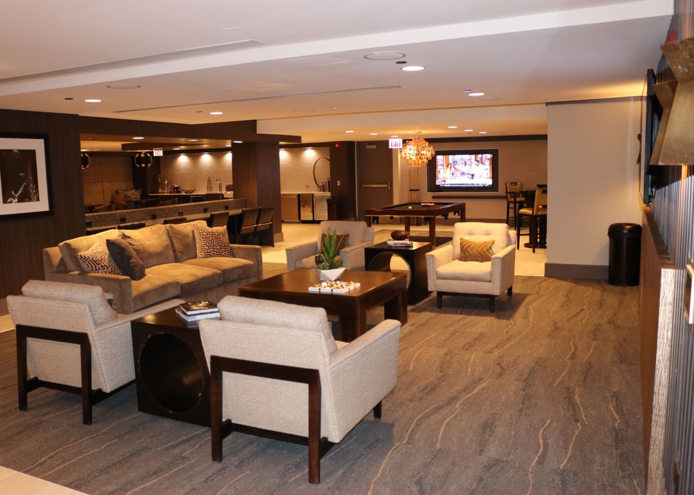 A room with multiple couches and cozy lighting.
