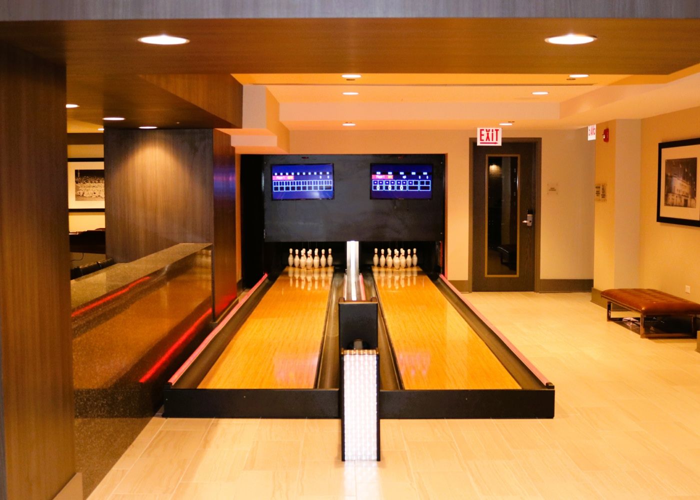 Two bowling lanes at Alta Roosevelt with bright lighting.