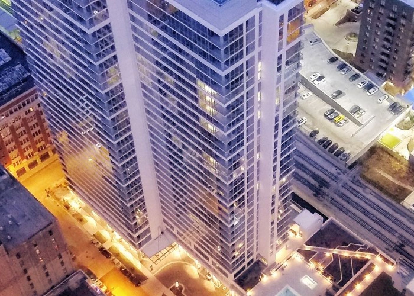 The exterior of Alta Roosevelt with bright lights at night.
