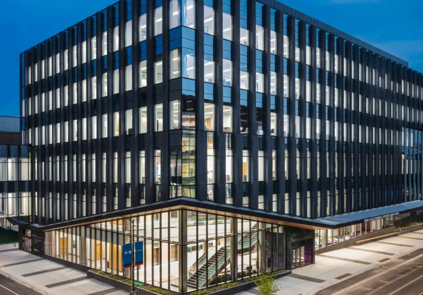 Exterior of the New UI Health Specialty Care Building in Chicago, IL at night.