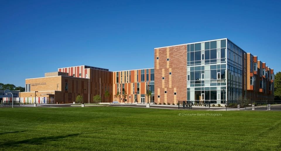 The exterior of East Prairie School surrounded by a large grass field.