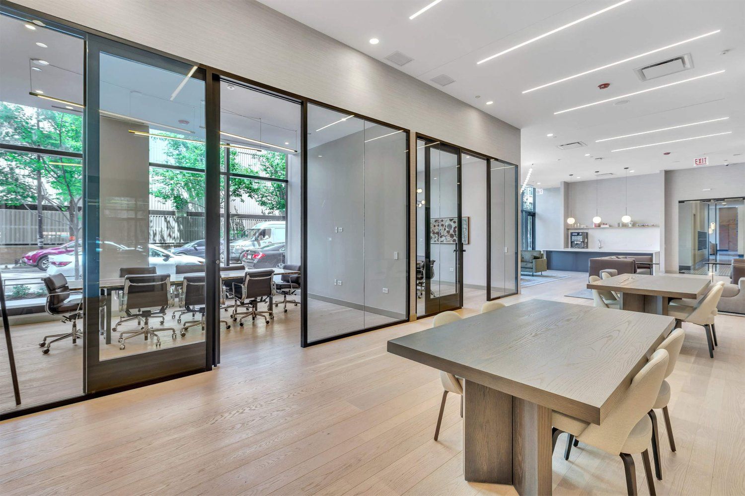 Meeting rooms inside 1101 W. Van Buren with glass-walls and office tables and chairs.