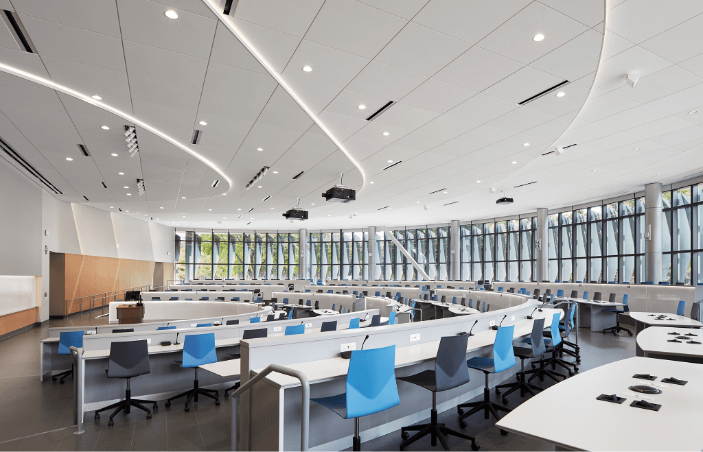 A large auditorium with many overhead ceiling lights.
