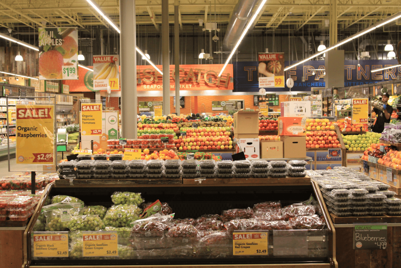 Fruit area of the Whole Foods supermarket, showing some grapes, apples and other more fresh produce.