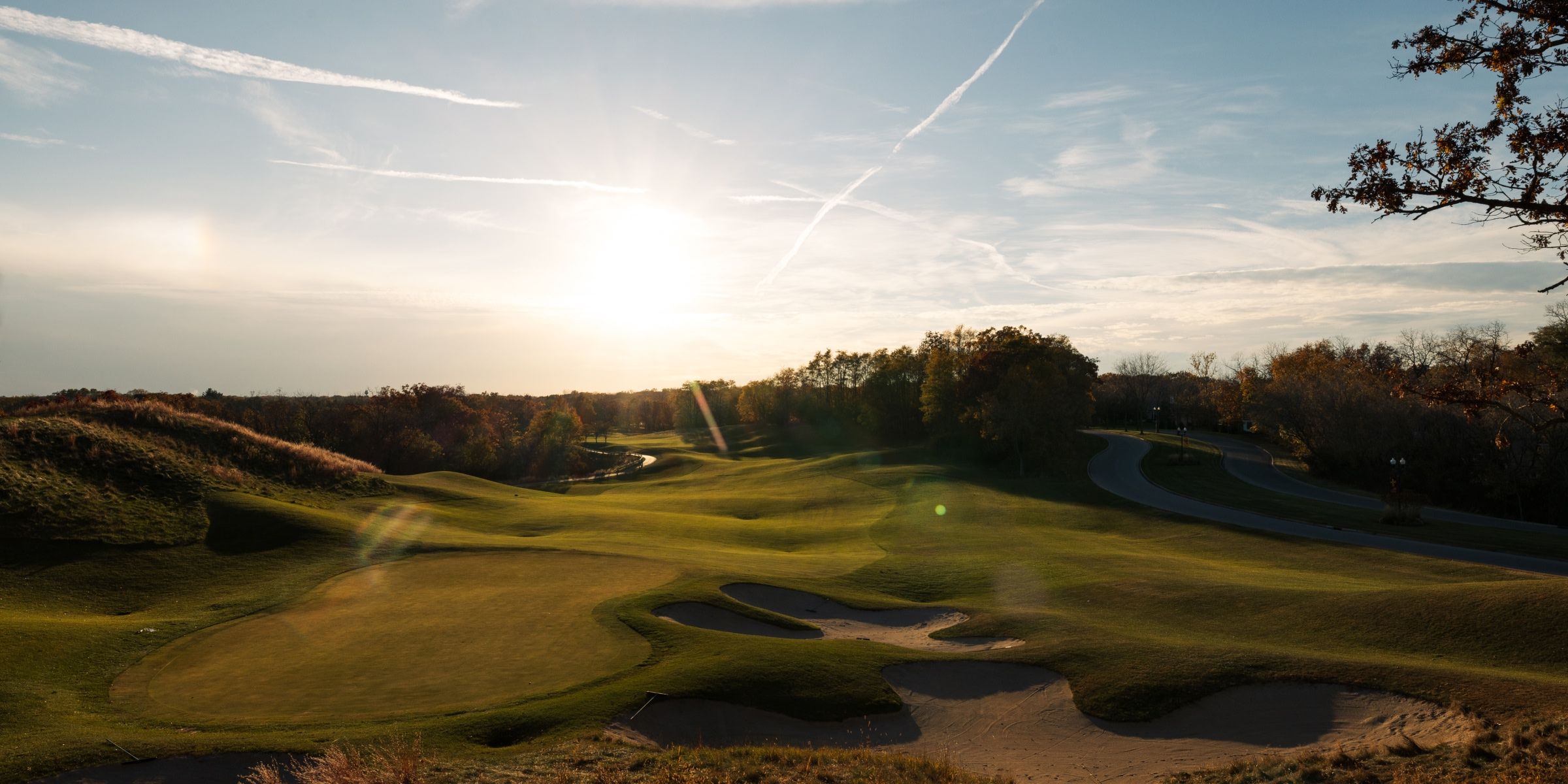 The sun shines down on Geneva National Resort's golf course covered in snow 