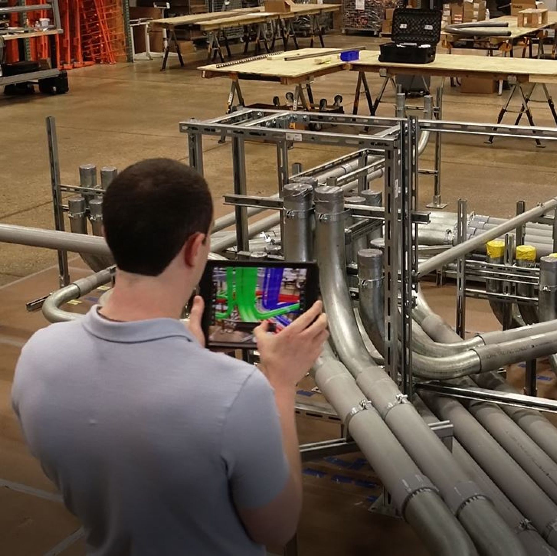 Electrical engineer viewing conduits in a Building Information Model (BIM) on a tablet