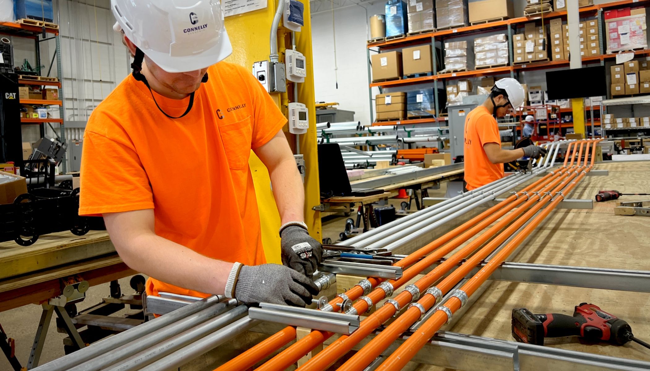 Connelly Electric electrician handling conduit bends in prefabrication center