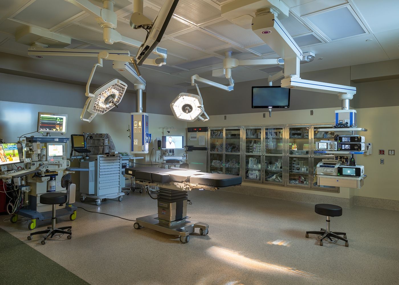 Surgery suite inside Mercy Health with an operating table and lights.