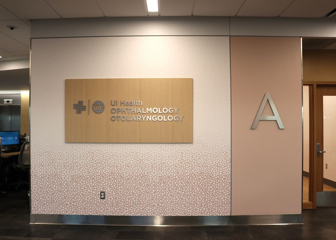 View of a wall that has the UI Health logo and under it reads "Ophthalmology Otolaryngology"