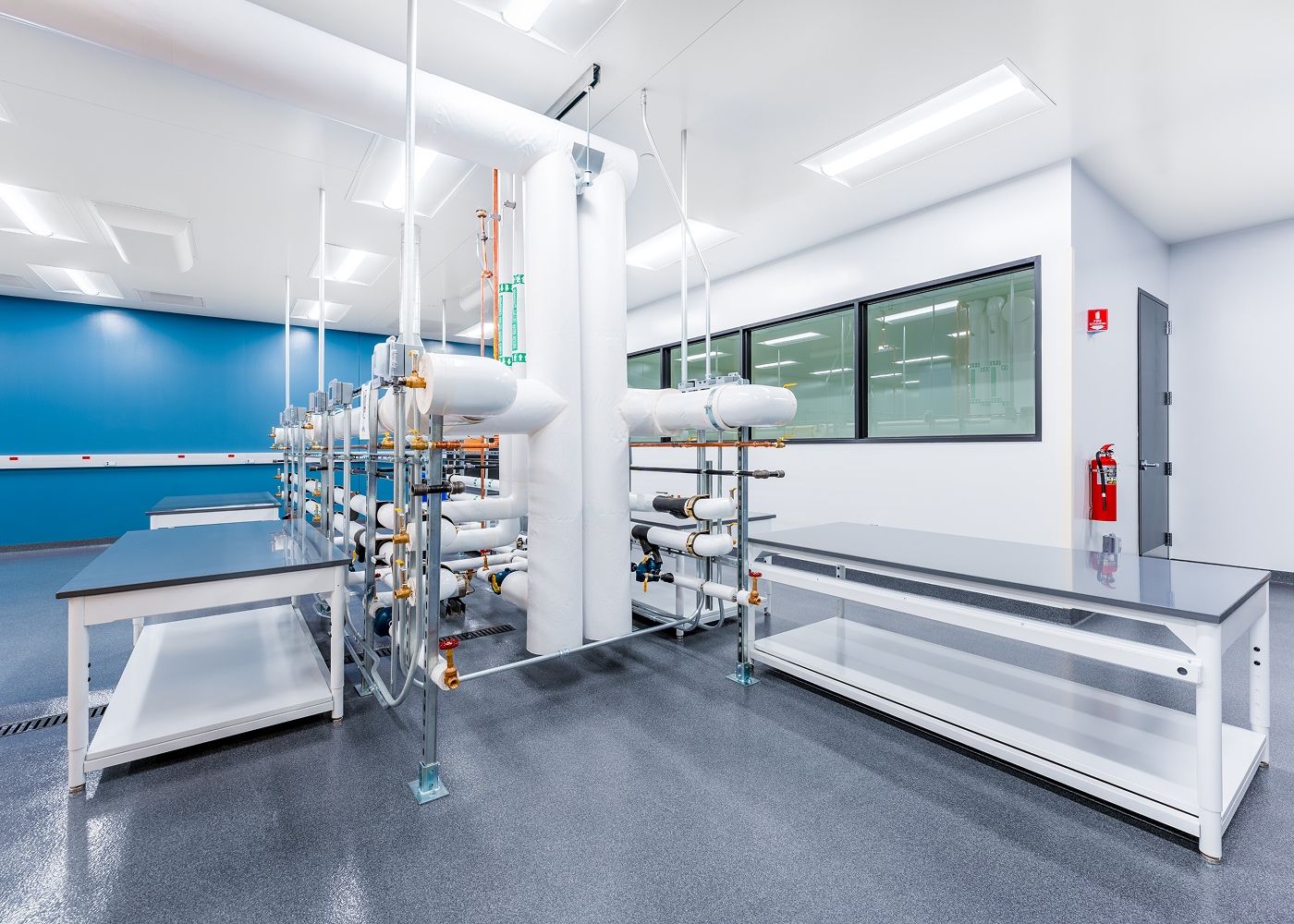Laboratory with tables, lab equipment and many ceiling lights to illuminate the space.