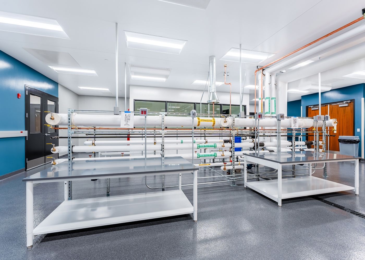 Laboratory with tables, equipment and many bright ceiling lights.