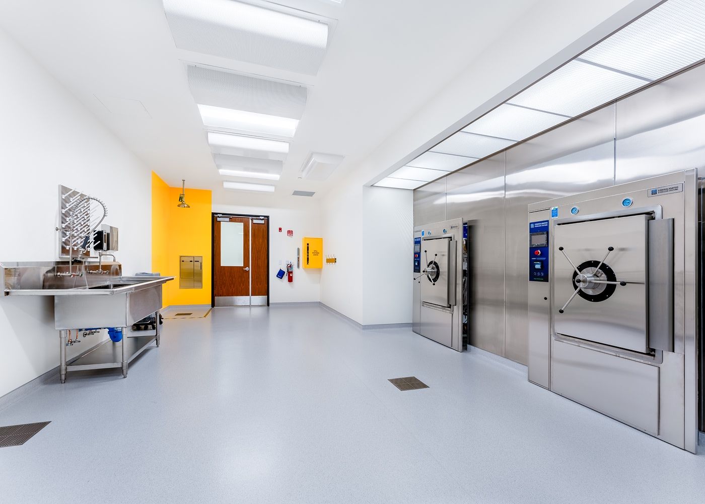 Laboratory with a sink, two safes and many ceiling lights to brighten up the space.